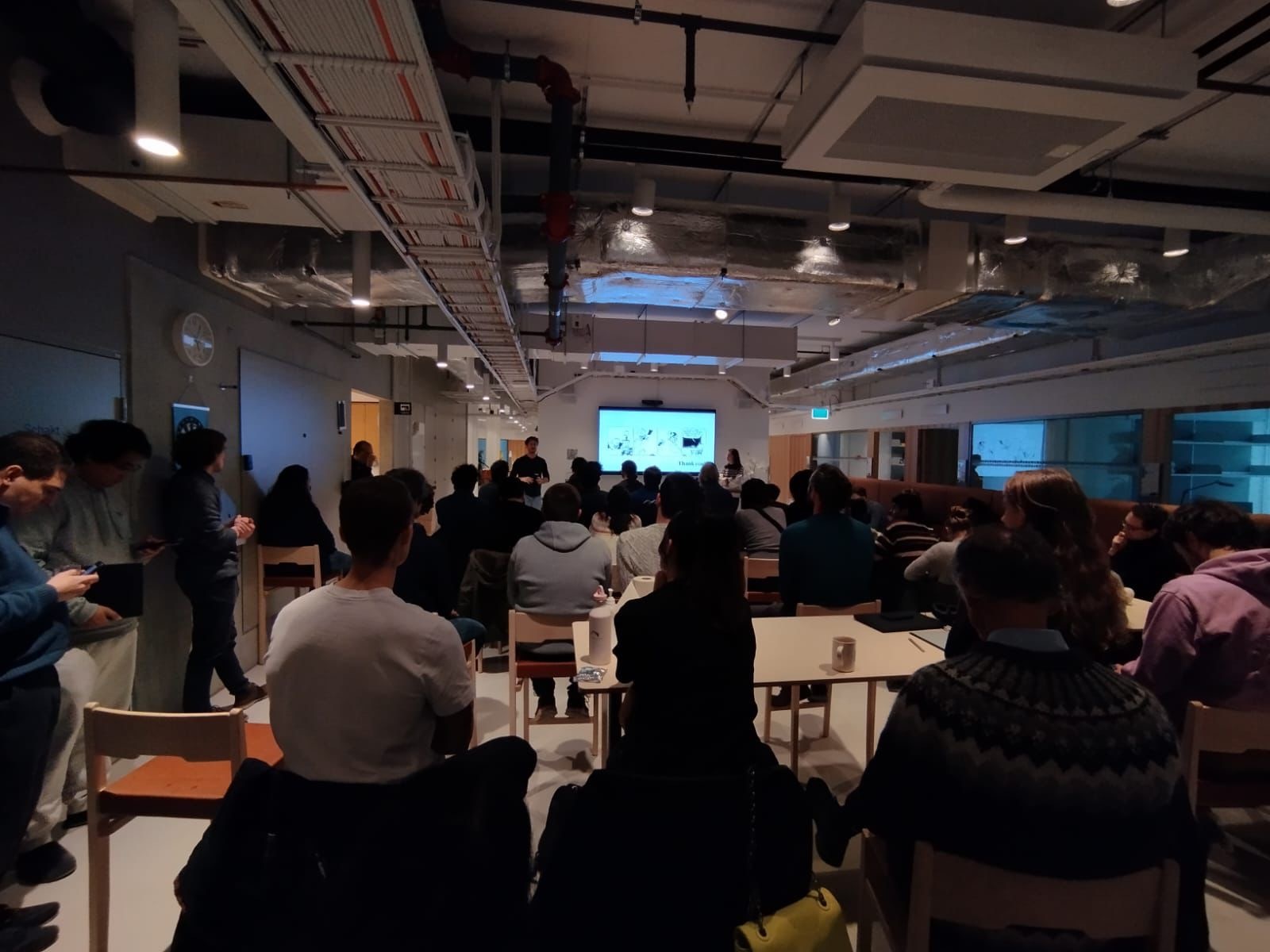Researchers gathered around tables for a ScientiFika talk